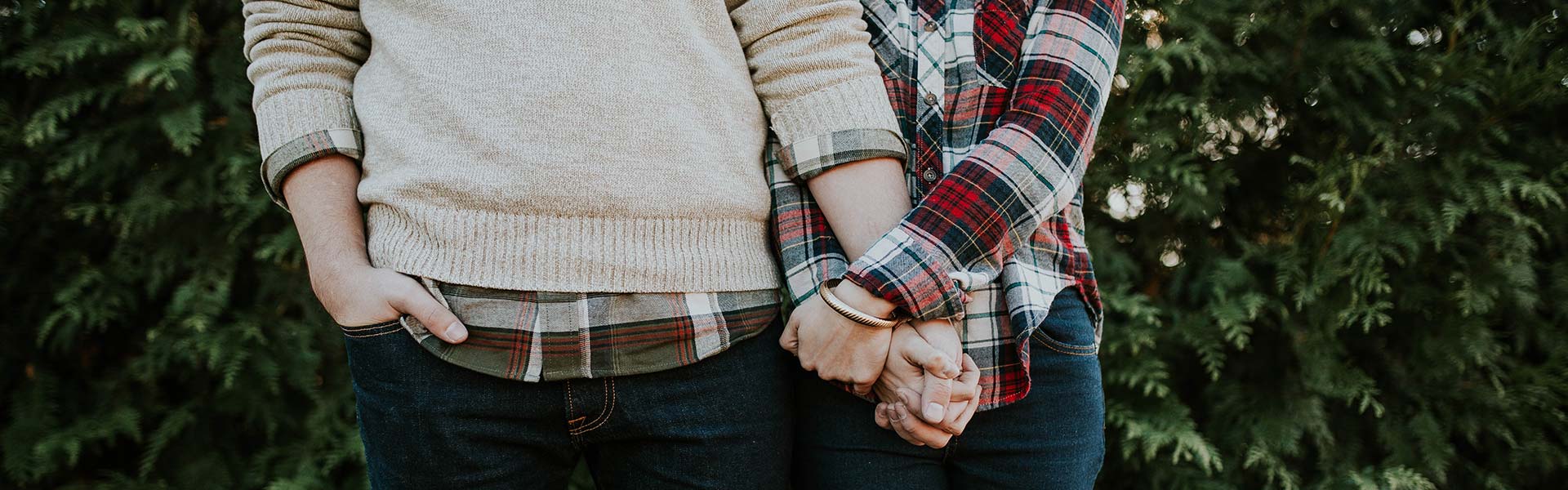 couple holding hands after talking about household finances.