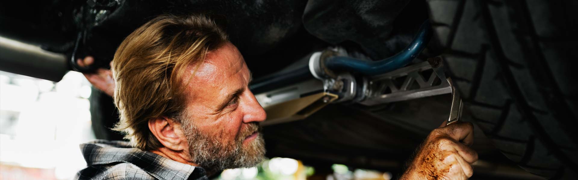 man performing maintenance on a vehicle