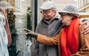 How to Stay on Budget During Black Friday - Man and woman window shopping during the holidays