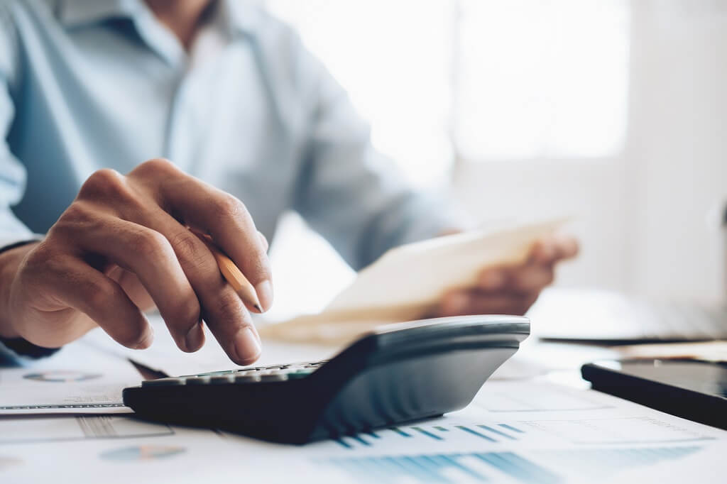 man working on a calculator