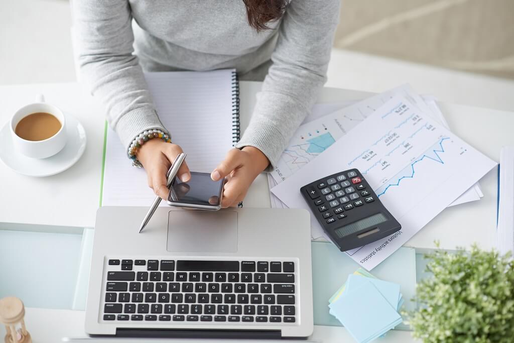 woman looking at her phone for ways to manage her debt