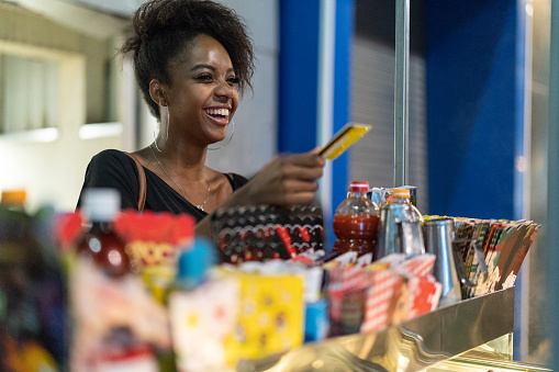 woman using a credit card to buy food