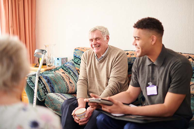 man on couch with a social worker during a medical emergency