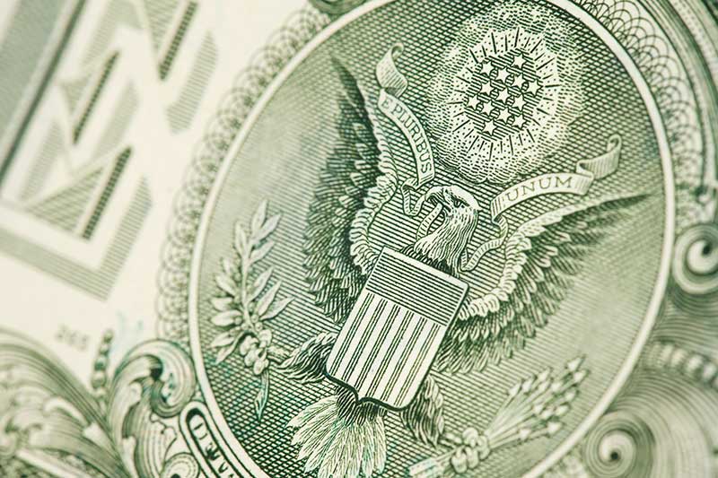 close up of united states seal on dollar bill