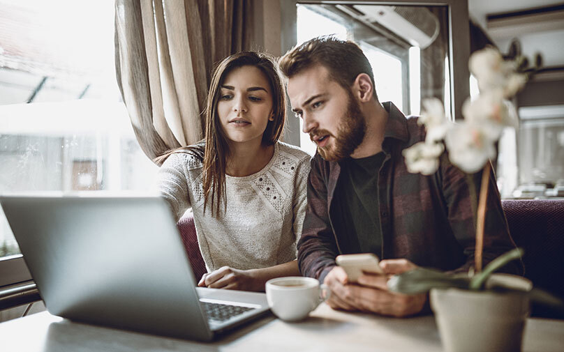Couple comparing loans online