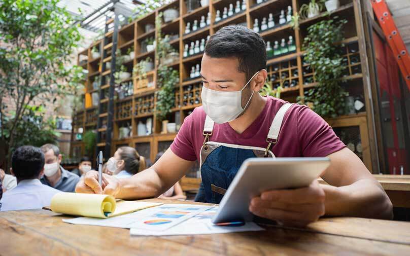 Man jotting down notes in notebook