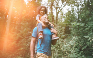 Father and daughter on hike in woods