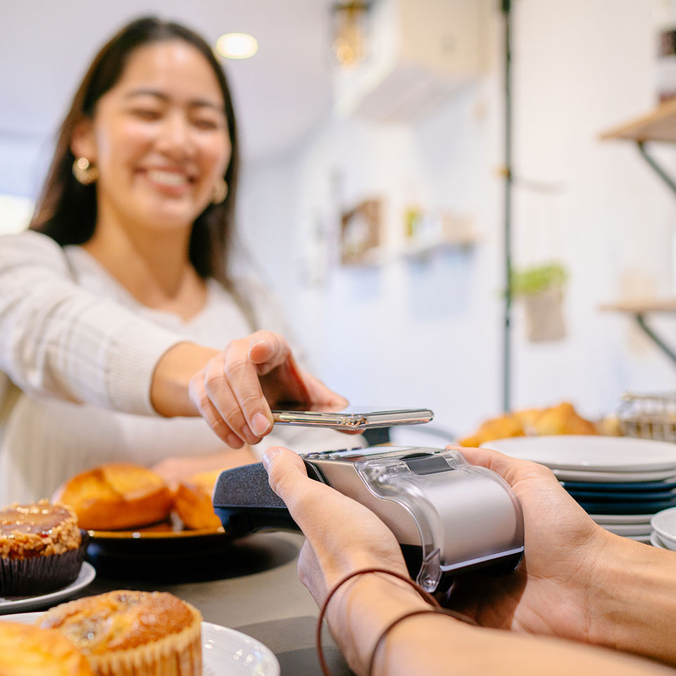 Woman paying for breakfast from her phone