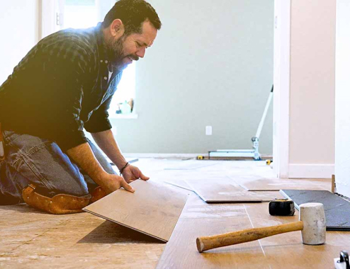 Man fixing a floor in his house