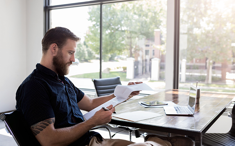 man sitting at desk understanding derogatory marks on his credit report