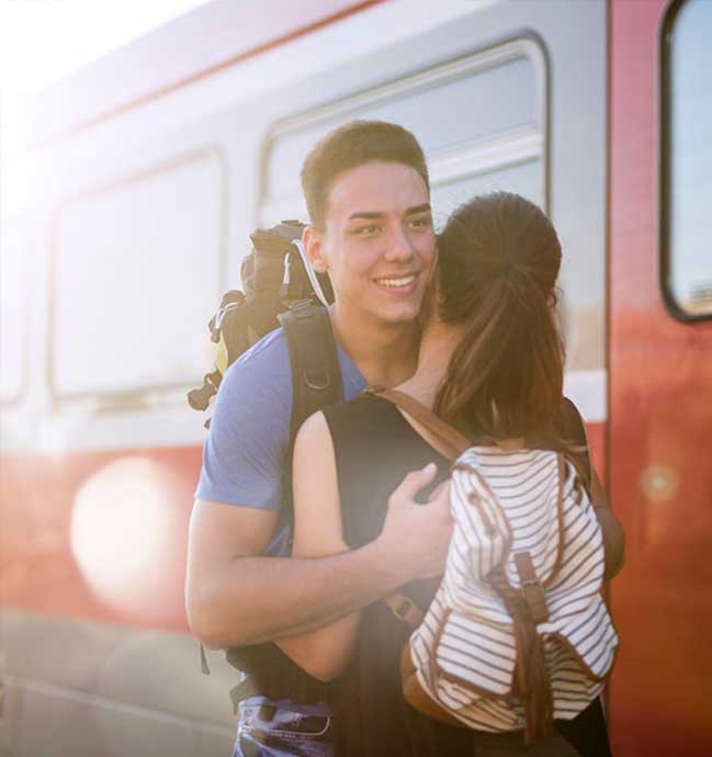 Couple hugging in train station