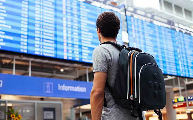 man at the airport learning about holiday travel tips