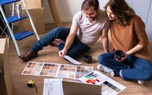 Couple planning home refresh ideas through repainting and new tiling