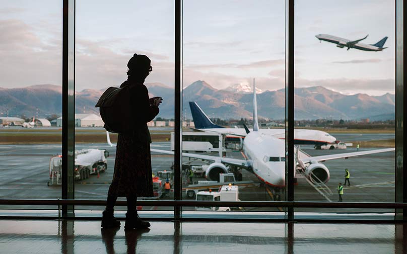 man at the airport learning how to pay for a vacation.