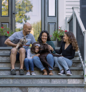 Family sitting on doorsteps