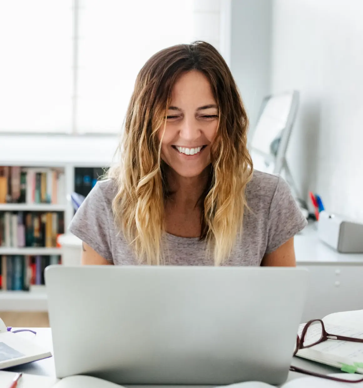 woman smiling at laptop