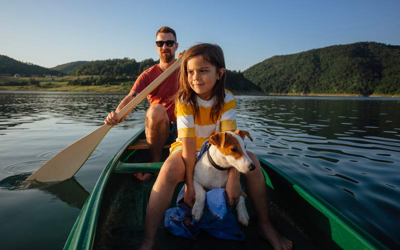 Father and daughter kayaking on the lake