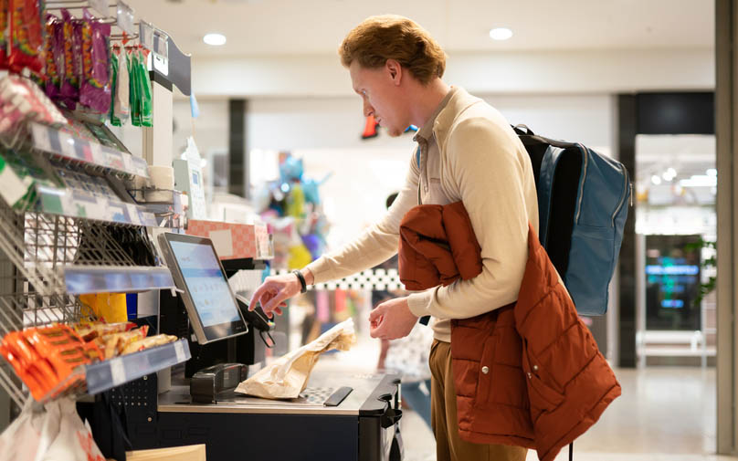 Man paying for groceries during inflation