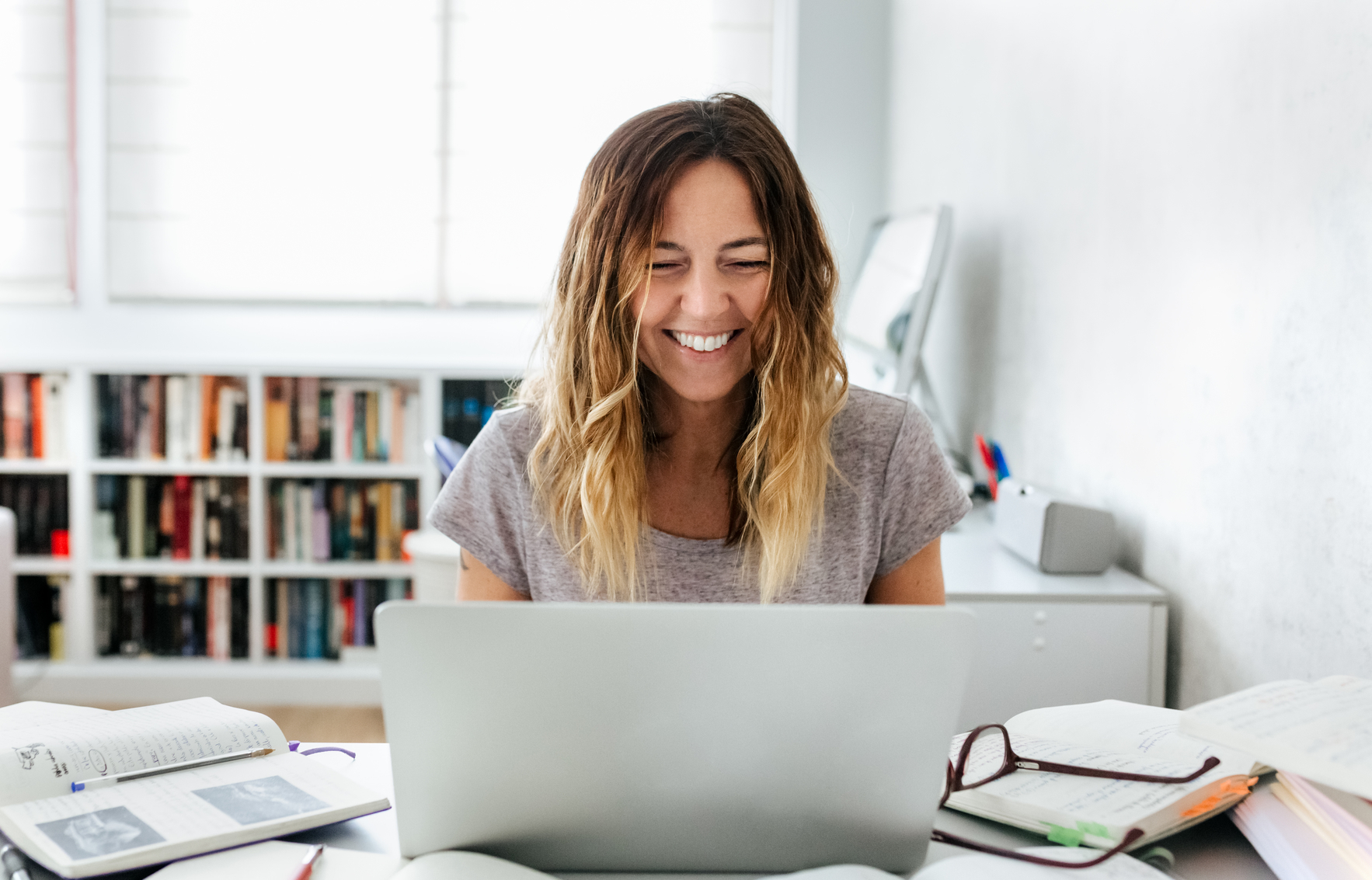 woman smiling at laptop