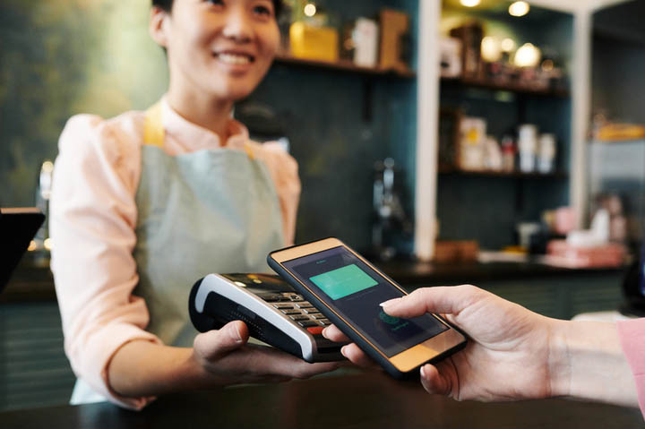 Person paying securely using mobile wallet