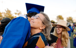 Mother hugging her child at their graduation