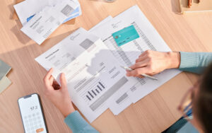 Person figuring out how debt consolidation loans work on paper