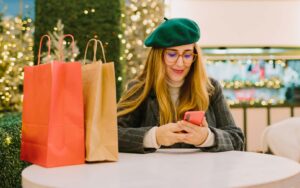 Women in glasses, holiday shopping looking at phone