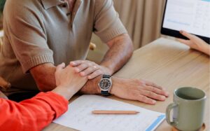 Close up of woman consoling man about medical debt