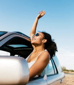 Woman enjoying the breeze out of the passenger side window